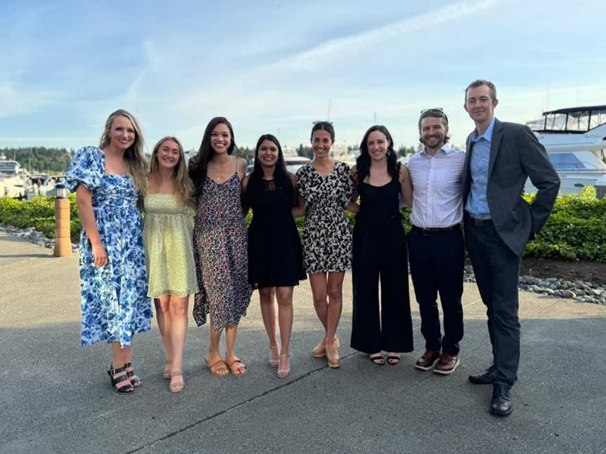 Photo of 8 fellows standing outside