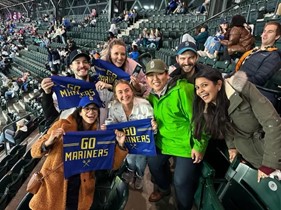 A group of fellows attend a Mariner's game.