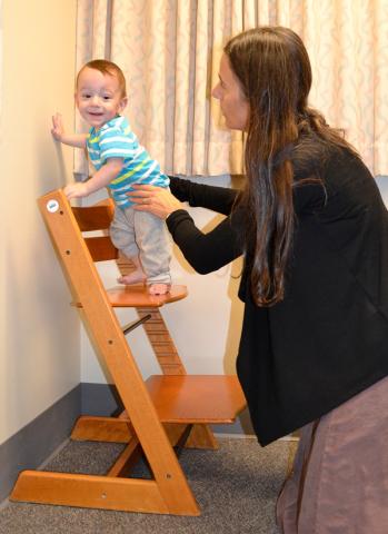 Photo of a young child standing on steps during a screening at an IHDD Clinic.